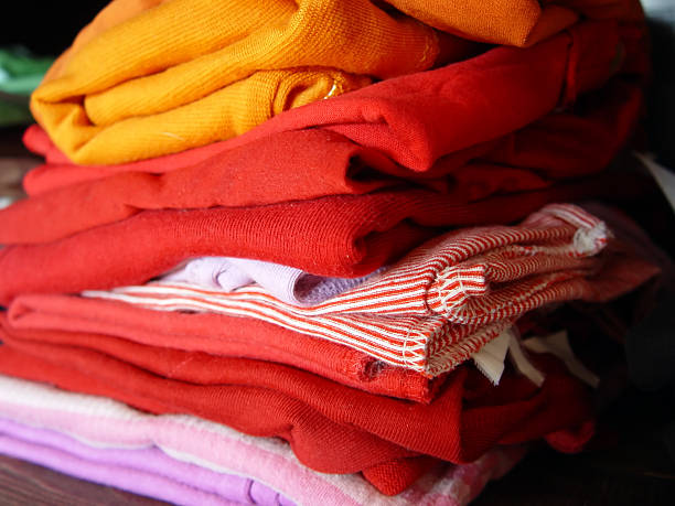 Colorful clothes folded on the shelf.