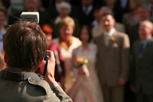 Wedding photographer makes picture of the family and Bride, Groom