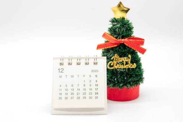 istock December's calendar and Christmas Tree isolated on white background. Christmas background. 1792897359