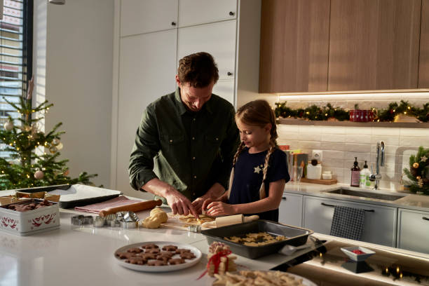 istock Caucasian father  and daughter making gingerbreads in domestic kitchen 1792901663
