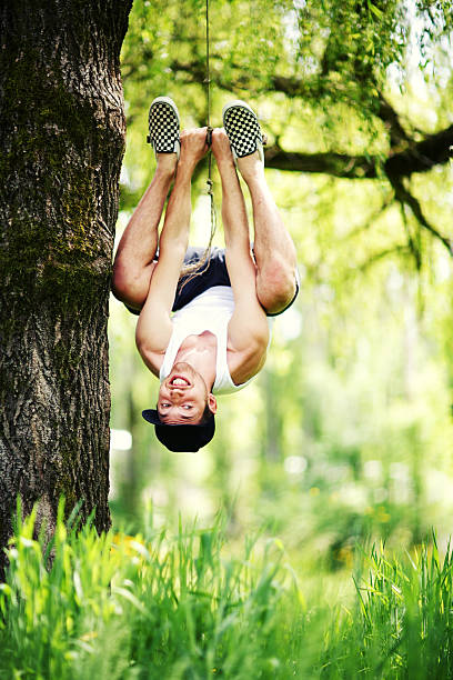 istock Male Hanging Upside Down from Rope Swing 179290224