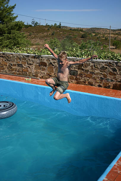 istock Boy jumps in the pool 179290497