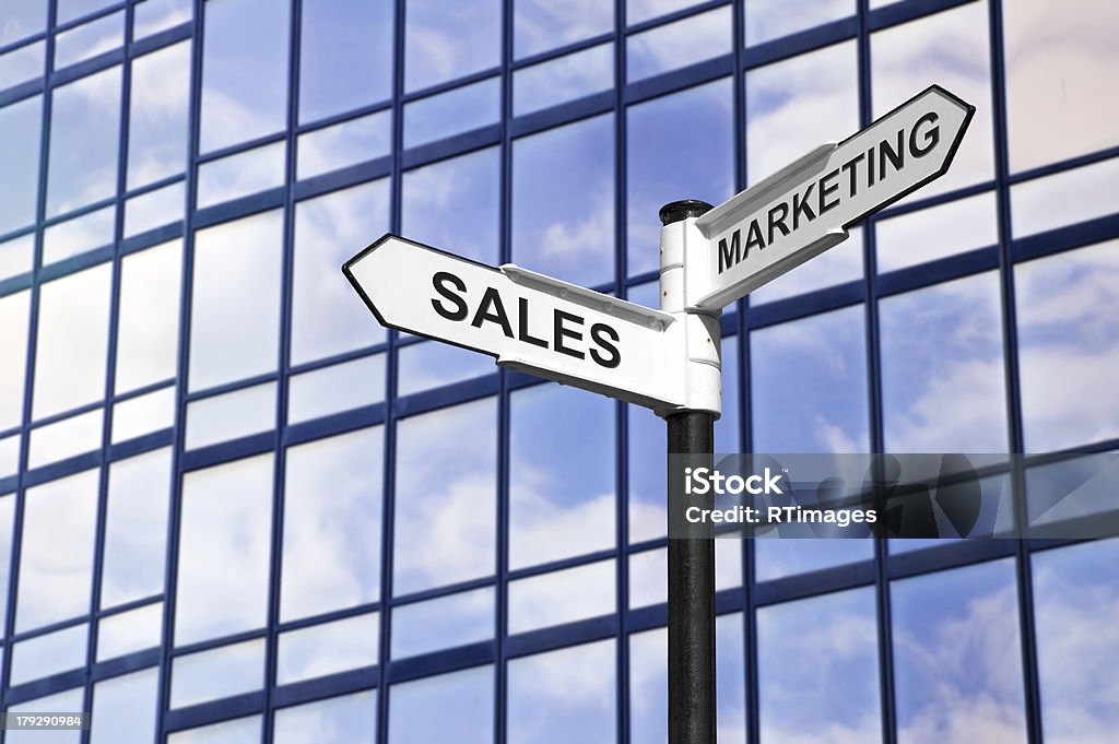 Sales & Marketing business signpost Concept image of Sales & Marketing on a signpost against a modern glass office building. Backgrounds Stock Photo