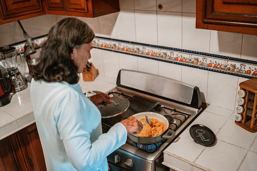 Senior woman cooking in the kitchen at home
