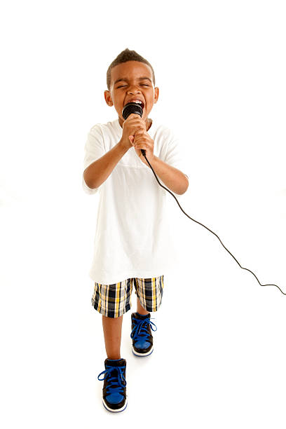 istock Little Boy Performs a Song with Microphone. 179292095