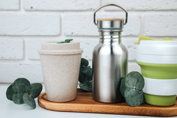 istock Set of devices for cold and hot drinks. Zero waste concept. A tin bottle for water and a mugs for coffee, tea on a wooden handle 1792922356