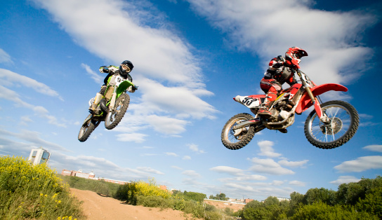 two motocross riders in the air