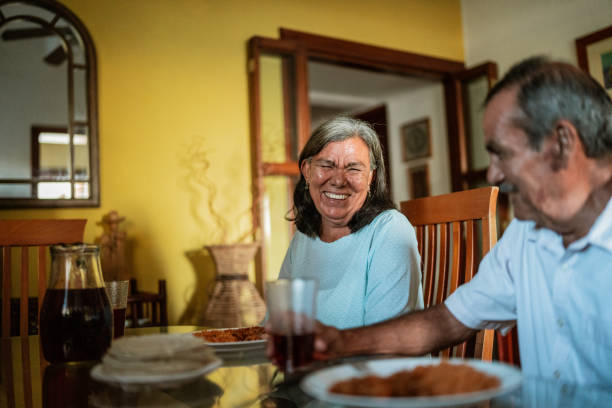 istock Senior couple talking while eating in the dining table at home 1792928335
