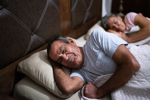 Senior man sleeping in the bedroom at home