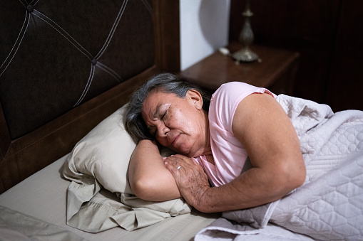 Senior woman sleeping in the bedroom at home