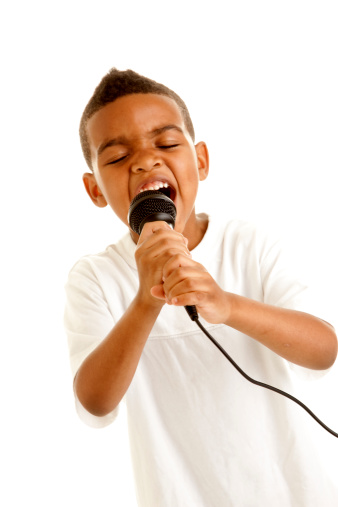 Little boy singing his heart out into a microphone.