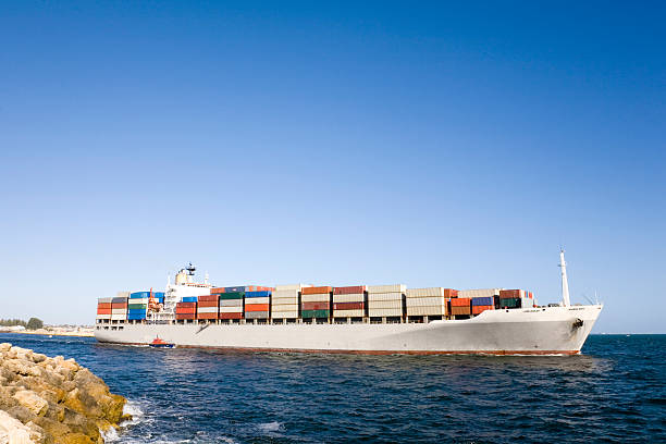 istock Large Container Ship Leaves Port Accompanied By Pilot Boat 179294569