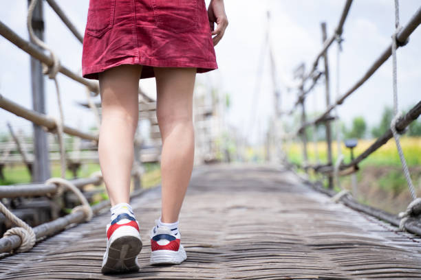 istock A woman walks on an old wooden bridge 1792952906