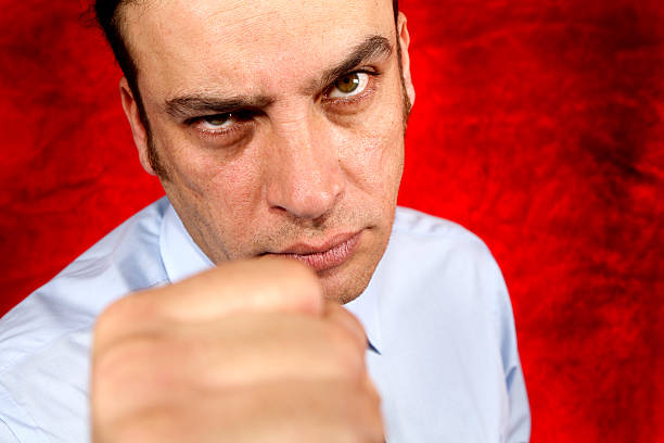 istock businessman raises fist 179295434