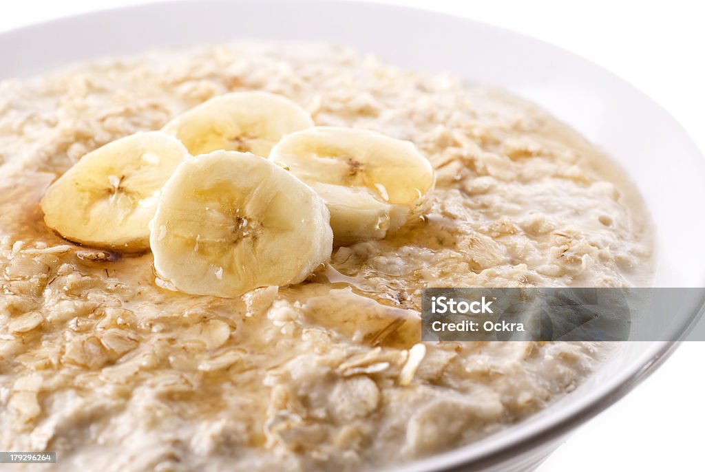 Porridge A bowl of warming porridge with sliced banana and honey/syrup. Banana Stock Photo