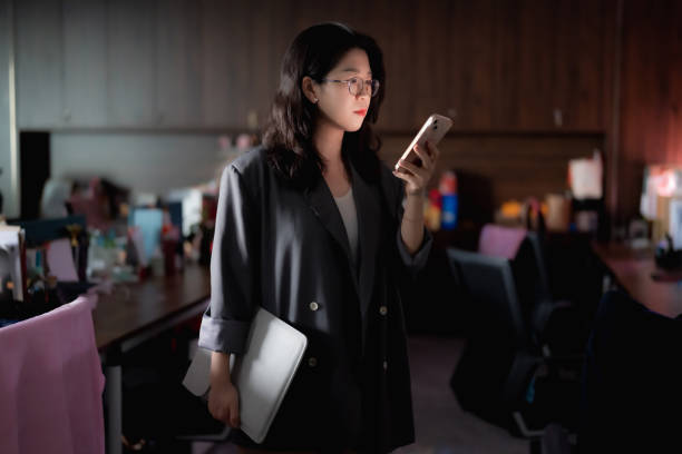 istock Woman working late and reading messages on smartphone 1792970044