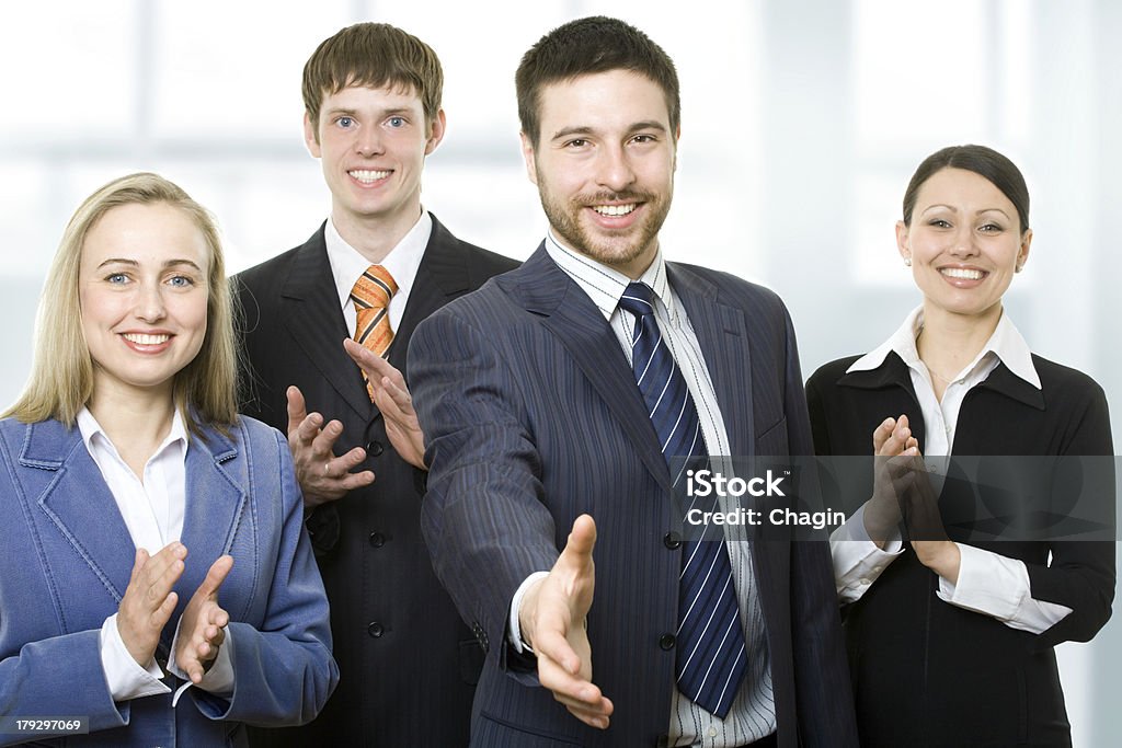 Successful smiling young business people Team of smiling businesspeople welcomes the colleague Adults Only Stock Photo