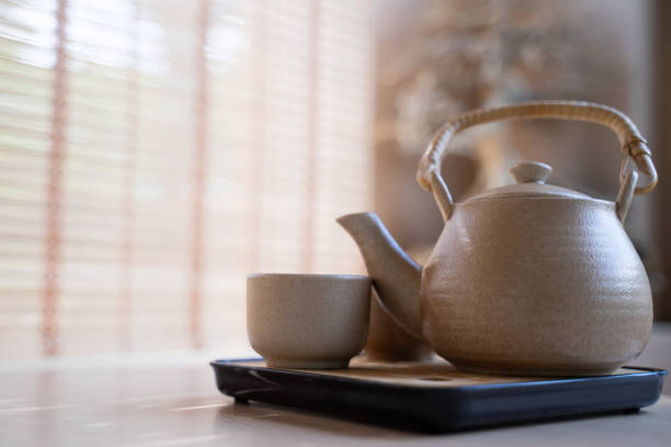 istock Teapot and tea cups, tea set on a tray placed on the table, blurred background, morning light 1792970760