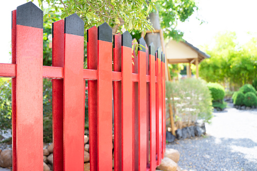 Chinese style red and black wooden fence used to decorate the garden.