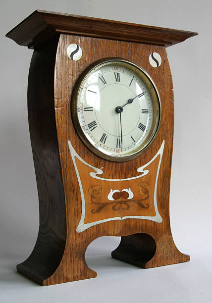 Antique Clock 2 Arts and Crafts Oak Mantle Clock.  In the manner of C.F.A. Voysey withYin-Yang roundel motifs and Art Nouveau design both inlaid with pewterand fruit woods. Circa 1900 mickey mantle stock pictures, royalty-free photos & images