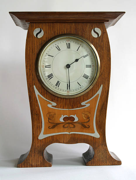 Antique Clock 1 Arts and Crafts Oak Mantle Clock.  In the manner of C.F.A. Voysey withYin-Yang roundel motifs and Art Nouveau design both inlaid with pewterand fruit woods. Circa 1900 mickey mantle stock pictures, royalty-free photos & images