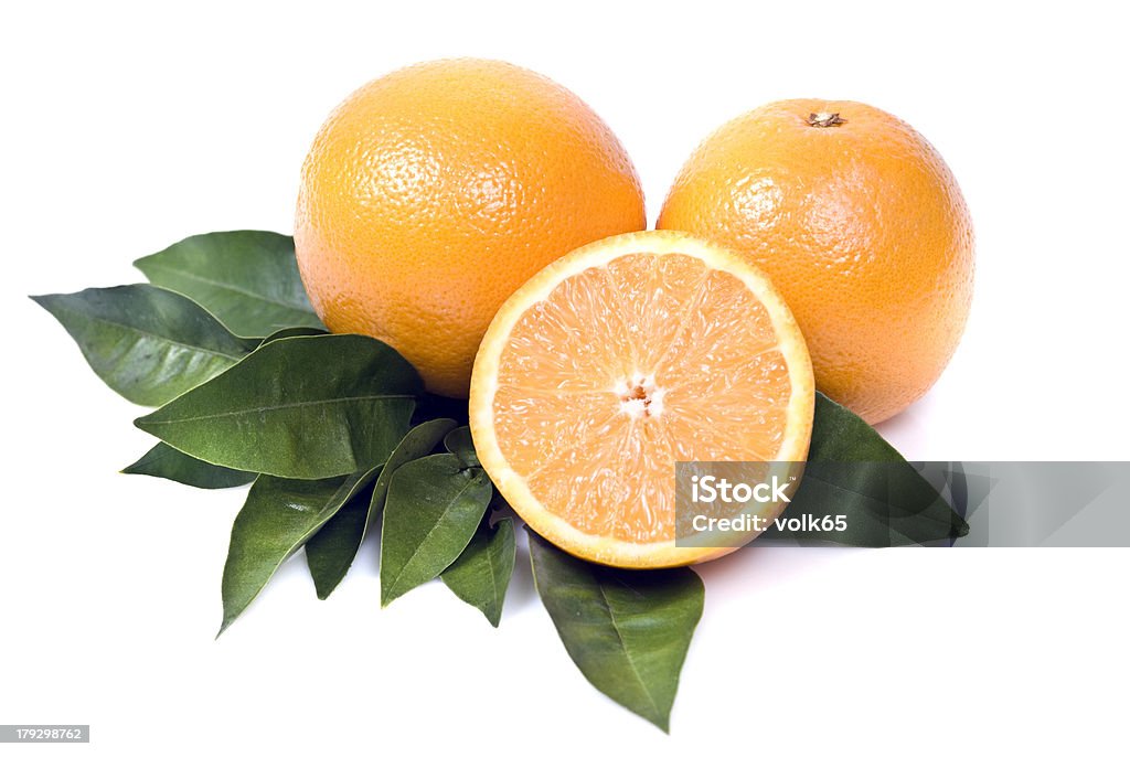 Oranges Two and a half orange on orange tree leaves. Isolated on white Cut Out Stock Photo