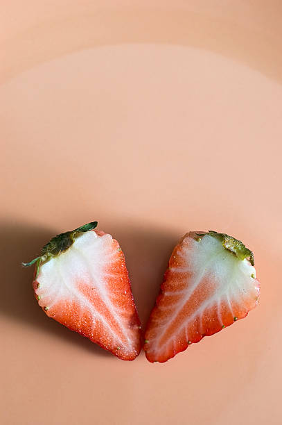 istock two pieces of cuted strawberryy on a plate 179299250