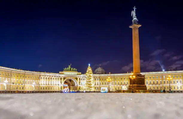 Photo of New Year's tree on the Palace Square and the arch of the General Staff building in St. Petersburg in the  winter night.