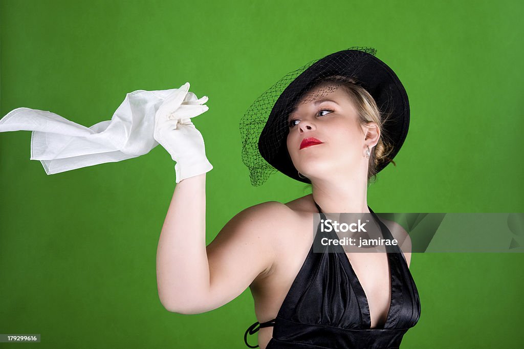 Wind Blowing My Hanky a beautiful young woman wearing a vintage hat looking back over her shoulder at her handkerchief blowing in the wind Adult Stock Photo