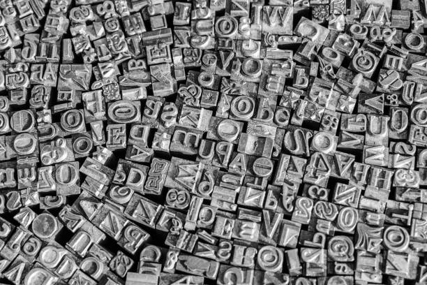 istock A black and white textured background of lead type-setting letter blocks with various fonts, upper- and lowercase, antique letters. 1793001663