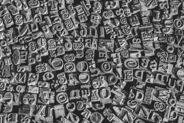 istock A black and white textured background of lead type-setting letter blocks with various fonts, upper- and lowercase, antique letters. 1793001665