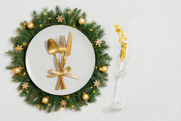 istock Festive table setting with Christmas wreath and golden decorations on white background with copy space. Happy new year. Space for text. Top view, flat lay. 1793010662