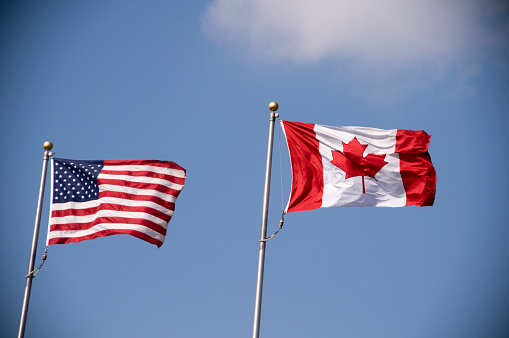 American and Canadian flag flying side by side.