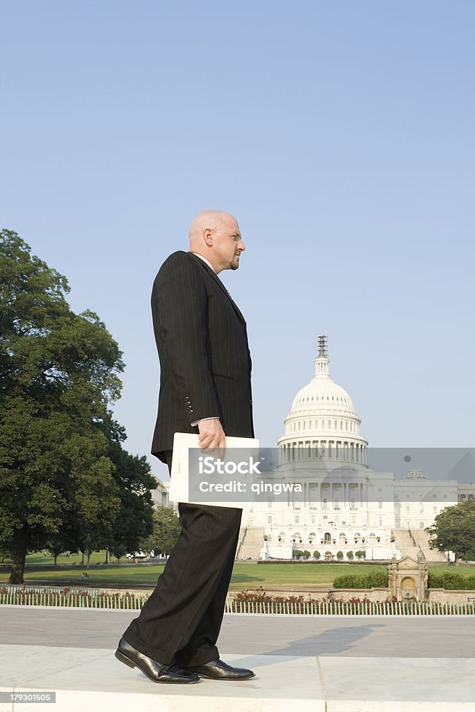 Well Dressed Man (Congressional Staff?) Walking with Folder Marked &quot;SECRET&quot; Well dressed man (Congressional staff) walking with folder marked secret.   - See lightbox for more Business Person Stock Photo