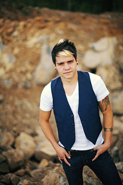 istock Young Man with Arm Tattoo on some Rocks 179301540