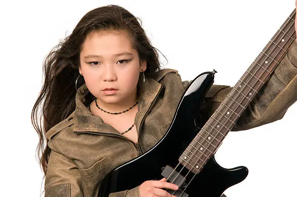 Young girl with electro guitar.
