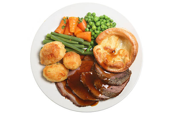 White plate with roast beef and vegetables
