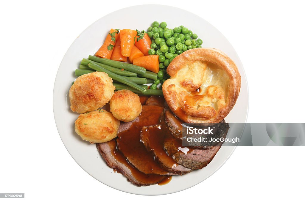 White plate with roast beef and vegetables Traditional Sunday roast dinner with roast beef, yorkshire pudding and vegetables Roast Dinner Stock Photo