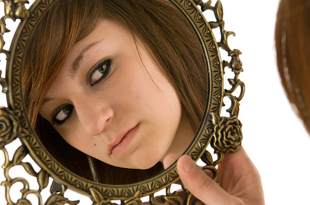 istock Woman looking in mirror 179302615