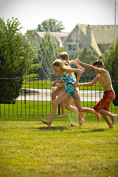 istock Summer Fun Children Play in the Sprinkler 179302831