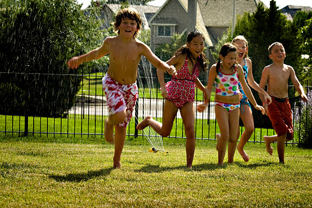 Summer Fun Children Run through in the sprinkler.