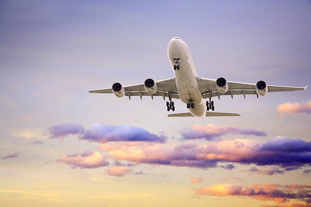 istock Jet Aeroplane Landing From Sunset Sky Purple Yellow Horizontal 179303954