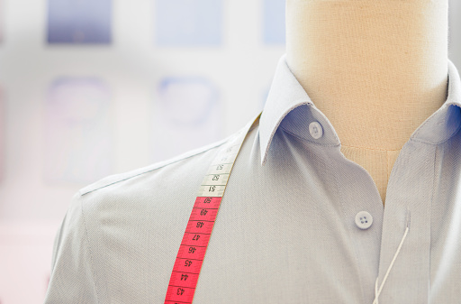 Close up of a blue oxford style formal shirt pocket and buttons to provide a background