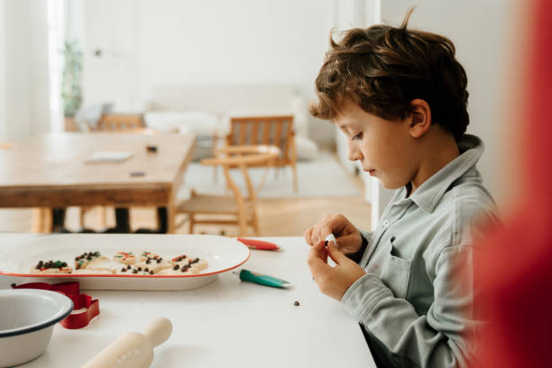 istock Boys decorating Christmas cookies 1793044751