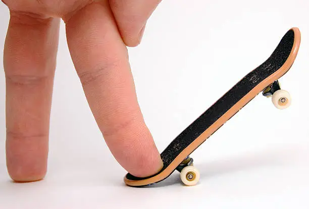 Photo of fingerboard with a human hand
