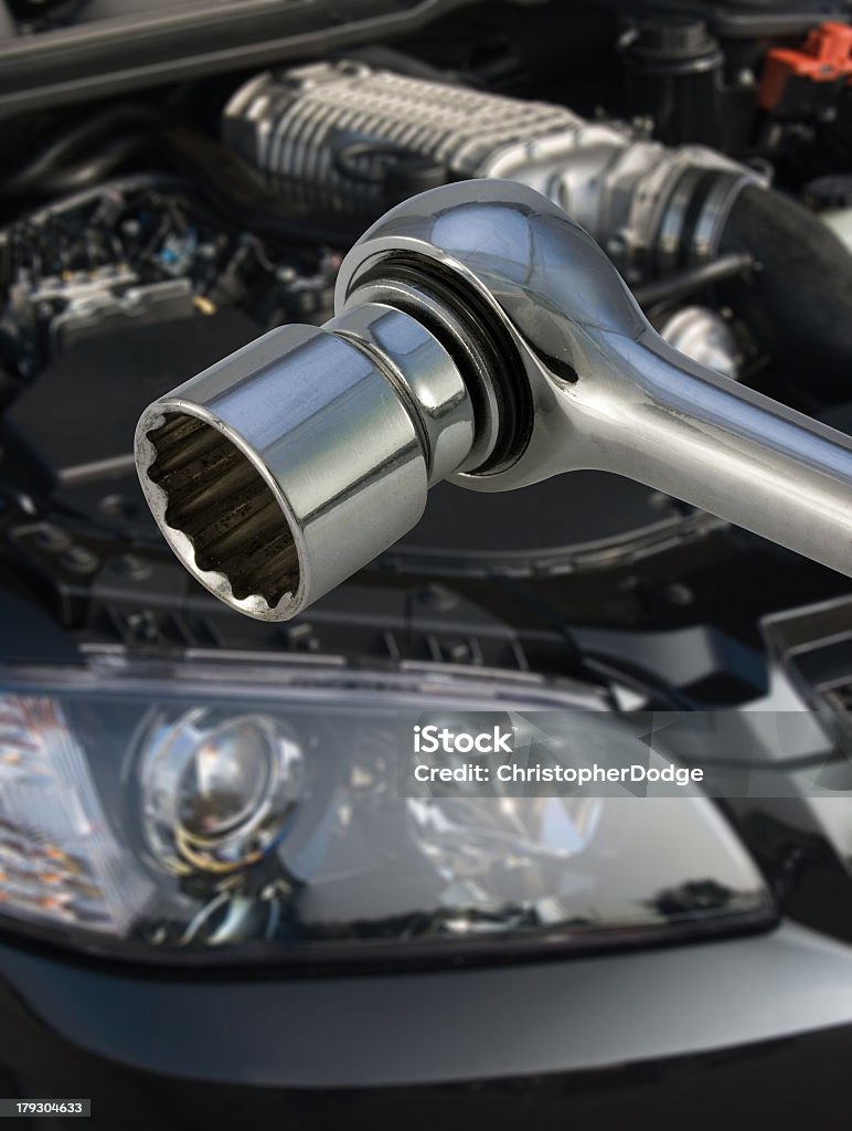 Socket spanner and engine Socket spanner with V8 supercharged car engine in the background Auto Repair Shop Stock Photo