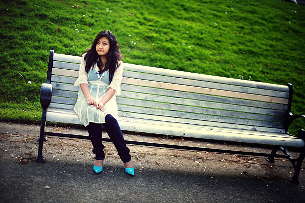 istock Young Asian Girl Sitting on a Park Bench 179304888