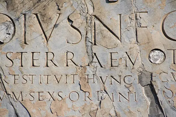 "Ancient latin script carved into marble. Ruins at Pompeii, Italy."