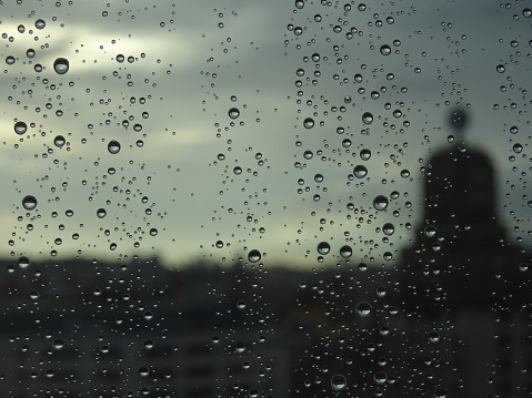 Rain drops on the window looking out over the city