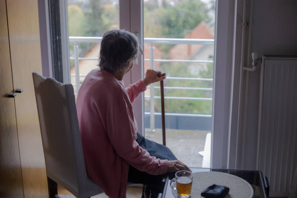 istock An old woman looks out the window 1793053608